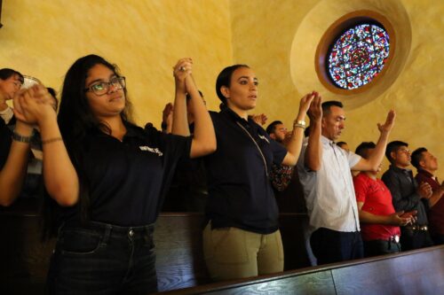 hispanic family praying at church