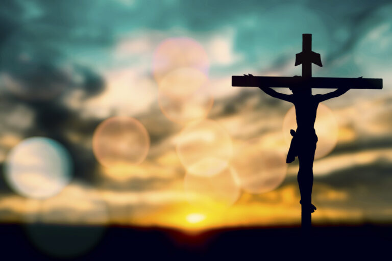 Silhouette of Jesus with Cross over sunset